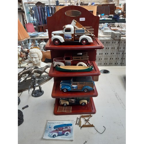 299 - Four American Ertl model pickups on mahogany display stand to include a 1947 Dodge, two 1940s Fords ... 