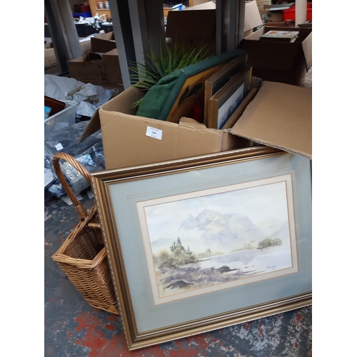 424 - A box containing mixed items to include artificial plants, photo frame, framed watercolour of a moun... 