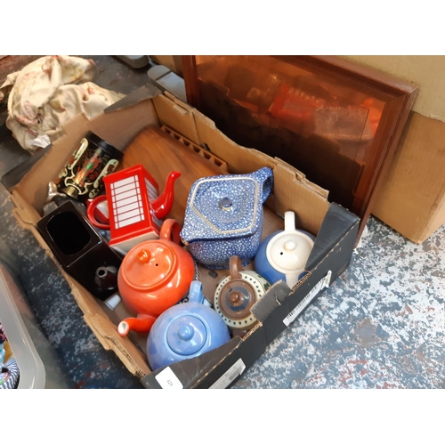 429 - A box containing mixed items to include collectors ceramic teapots, copper engraving of the Lancaste... 