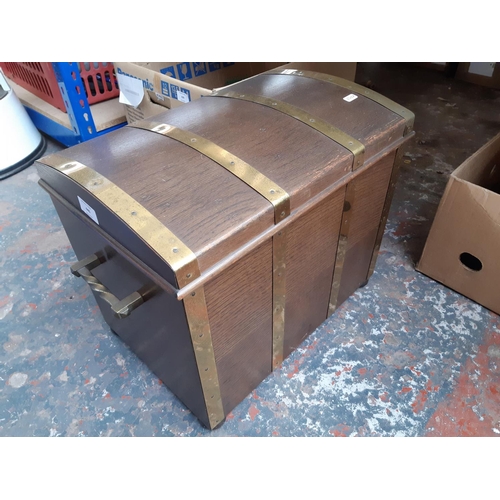 440 - A vintage oak and brass bound coal box in the form of a treasure chest - measuring approx. 39cm high... 