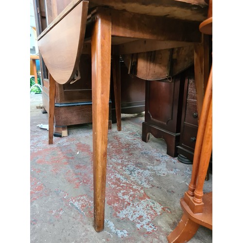 580 - A mid 20th century teak effect drop leaf dining table