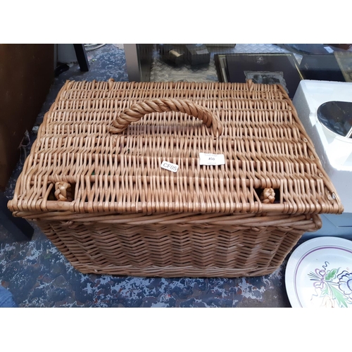 450 - A vintage wicker picnic basket with contents