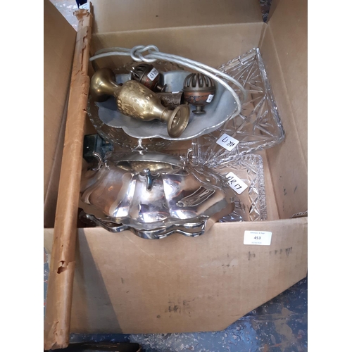 453 - A box containing assorted metalware and glassware