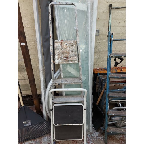 775 - A set of five tread aluminium step ladders together with a two tread metal step ladders