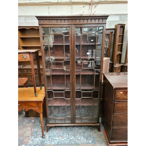 455 - An early 20th century mahogany display cabinet with two glazed doors - measuring approx. 189cm high,... 