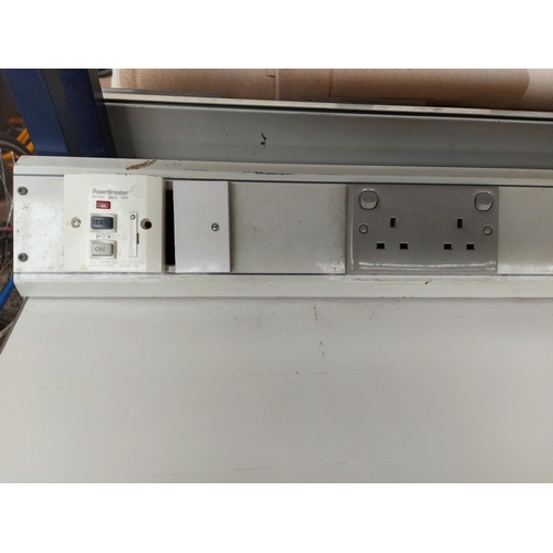 714 - A blue and grey Nortek electricians workbench with mounted plug sockets, overhead shelf and lower st... 