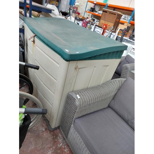 718 - A large green and beige garden storage cabinet - measuring approx. 146cm wide, 78cm deep and 100cm h... 