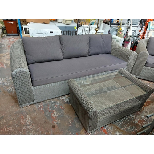 719 - A three piece grey plastic rattan effect conservatory suite comprising three seater sofa, armchair a... 