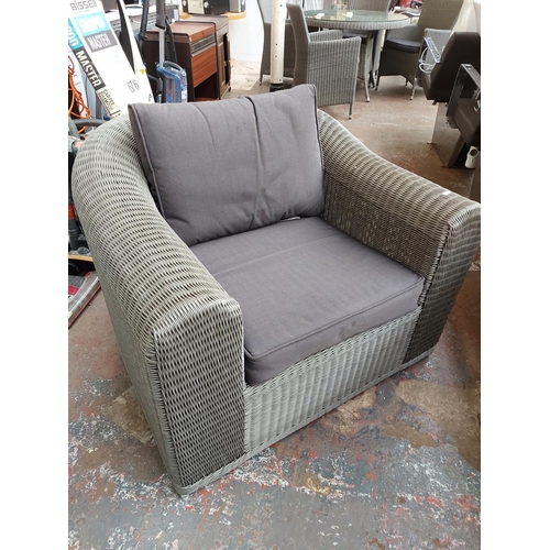 719 - A three piece grey plastic rattan effect conservatory suite comprising three seater sofa, armchair a... 