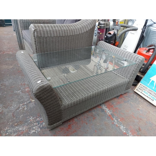 719 - A three piece grey plastic rattan effect conservatory suite comprising three seater sofa, armchair a... 