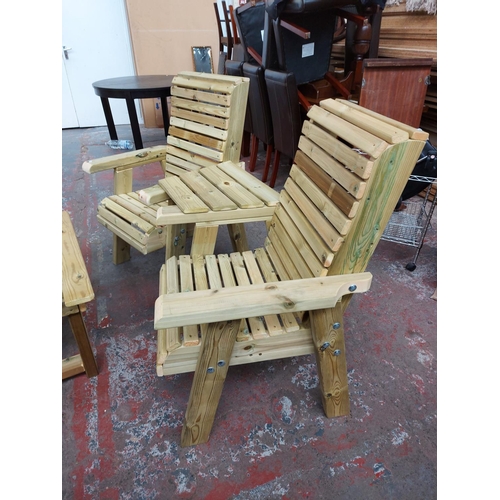 752 - A four piece Swedish Redwood garden set comprising two armchairs with central table and matching rec... 