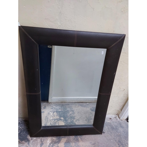 435 - Two mirrors to include a green painted framed bevelled edge mirror and a brown leather framed mirror