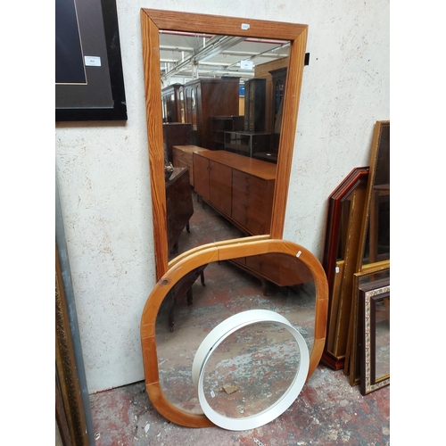 437 - Three various mirrors to include an Ikea Langesund white circular framed mirror and two pine framed ... 