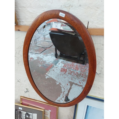 446 - An oak framed oval bevelled edge wall mirror