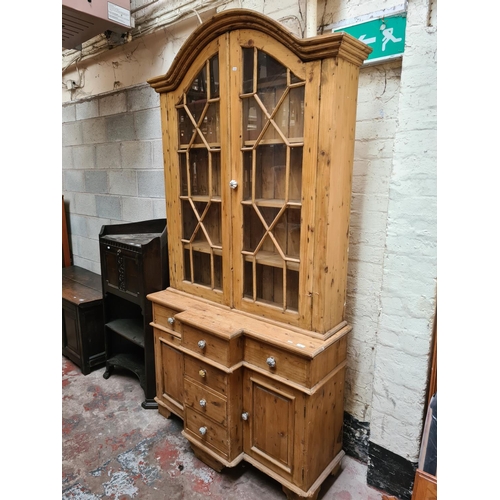 456 - A Victorian pine farmhouse dresser with two upper glazed doors, three internal shelves, four central... 