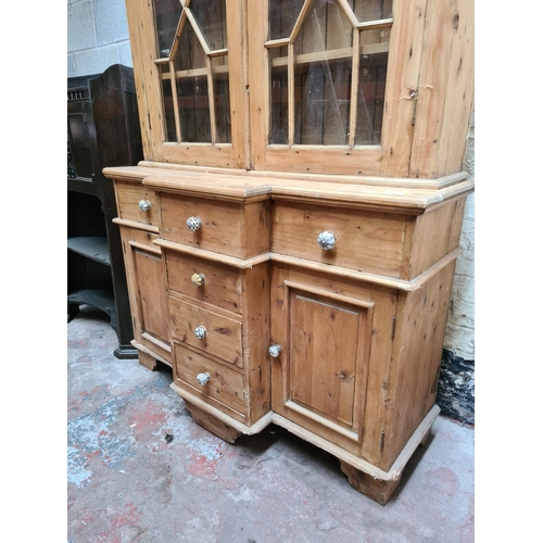 456 - A Victorian pine farmhouse dresser with two upper glazed doors, three internal shelves, four central... 