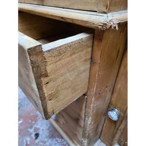 456 - A Victorian pine farmhouse dresser with two upper glazed doors, three internal shelves, four central... 