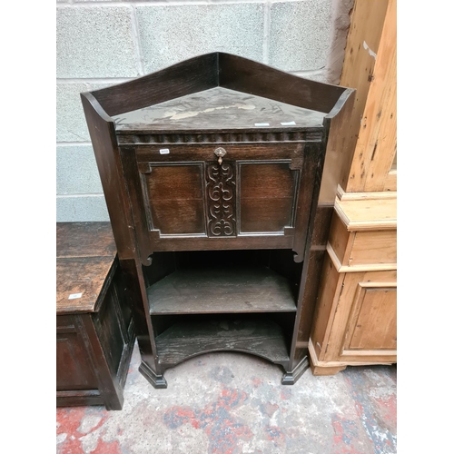 457 - An early 20th century oak freestanding corner bureau cabinet with fall front, internal storage and t... 