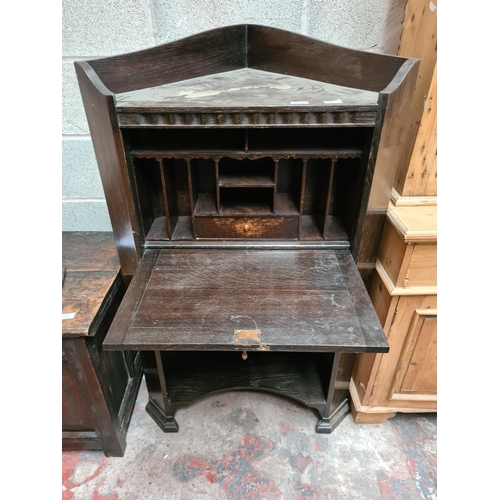 457 - An early 20th century oak freestanding corner bureau cabinet with fall front, internal storage and t... 