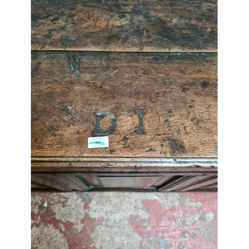 458 - An 18th century oak coffer - measuring approx. 61cm high, 124cm wide and 53cm deep