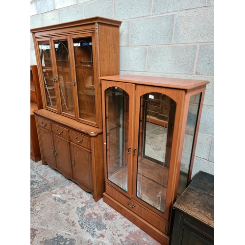 459 - Two items to include a Morris furniture teak effect display cabinet with two glazed doors and a simi... 