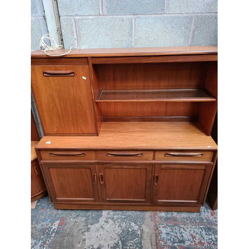 460 - A 1970s G Plan Fresco teak highboard with three drawers, three lower cupboard doors and fall front d... 