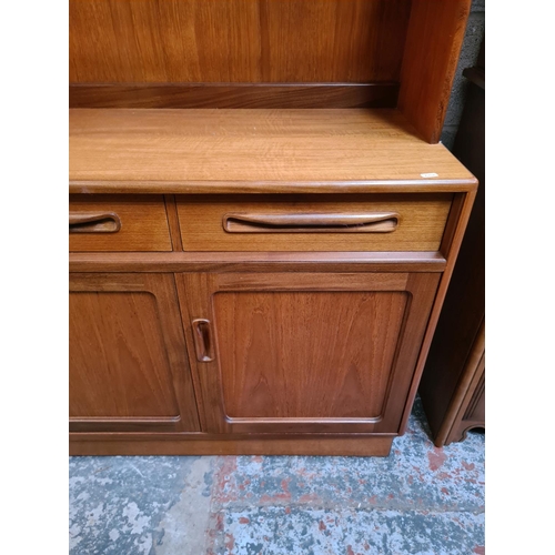 460 - A 1970s G Plan Fresco teak highboard with three drawers, three lower cupboard doors and fall front d... 