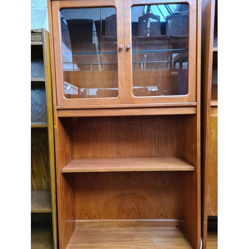 461 - A 1970s G Plan Fresco teak three piece living room suite comprising corner cabinet with two lower cu... 