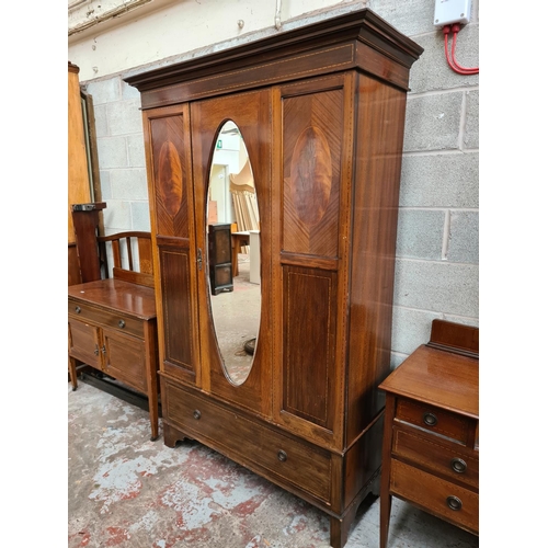 463 - An Edwardian inlaid mahogany four piece bedroom suite comprising dressing table with oval bevel edge... 