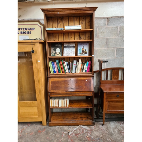 464 - A bespoke pine bureau bookcase with fall front, internal storage, four upper shelves and two lower s... 