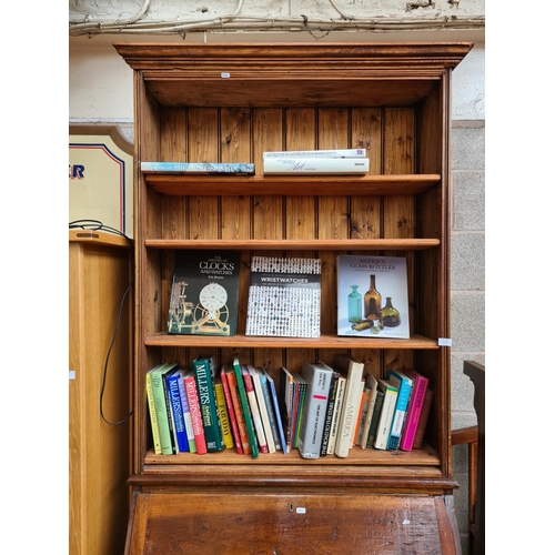 464 - A bespoke pine bureau bookcase with fall front, internal storage, four upper shelves and two lower s... 