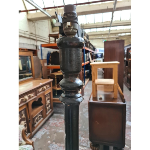 467 - A vintage ebonised standard lamp on stepped base