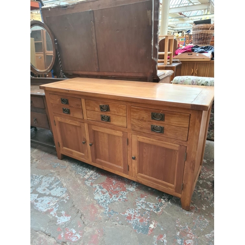 469 - A modern oak sideboard with three drawers and three lower cupboard doors - measuring approx. 160cm x... 