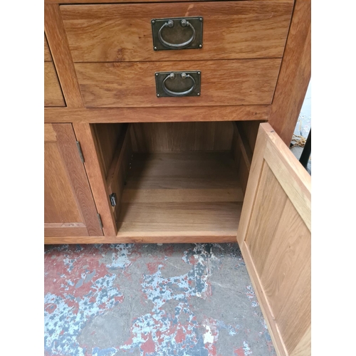 469 - A modern oak sideboard with three drawers and three lower cupboard doors - measuring approx. 160cm x... 