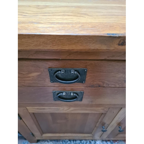 469 - A modern oak sideboard with three drawers and three lower cupboard doors - measuring approx. 160cm x... 