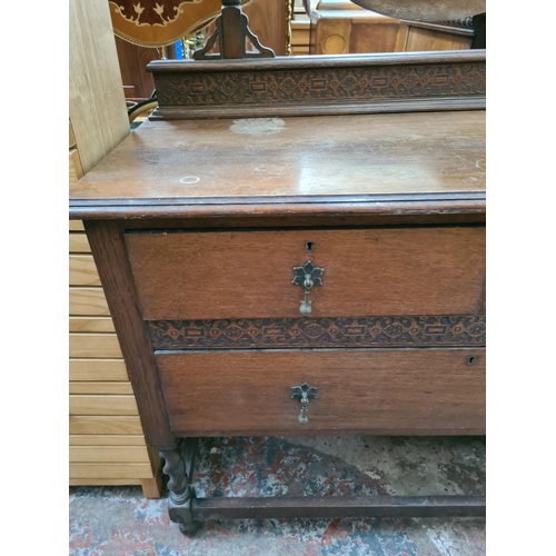 470 - An early 20th century oak dressing table on barley twist supports with upper bevel edged circular mi... 