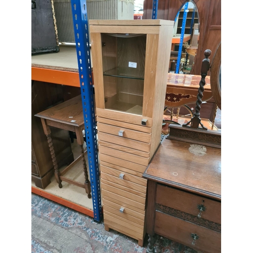 471 - A Next oak Natural Spar Midboy/bathroom cabinet with three drawers and one glazed door