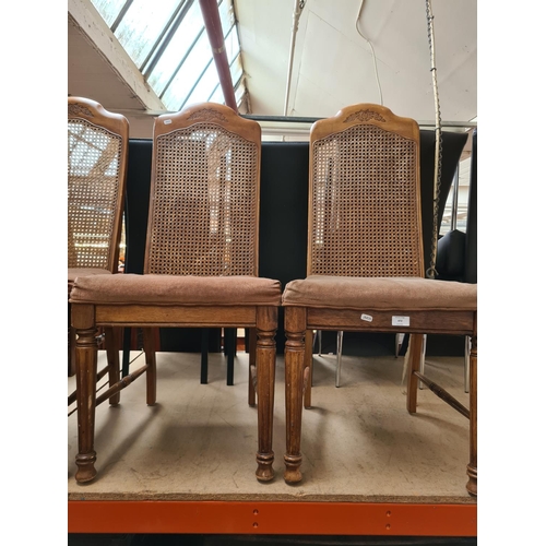 472 - Four French style walnut dining chairs with rattan backs and brown upholstery