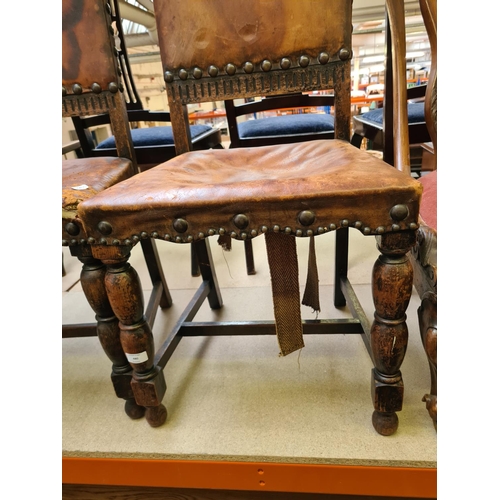 480 - Two early 20th century oak framed dining chairs with brown leather upholstery (see condition report)