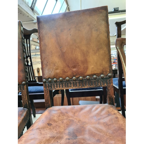 480 - Two early 20th century oak framed dining chairs with brown leather upholstery (see condition report)