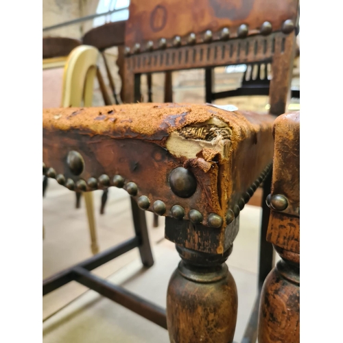 480 - Two early 20th century oak framed dining chairs with brown leather upholstery (see condition report)