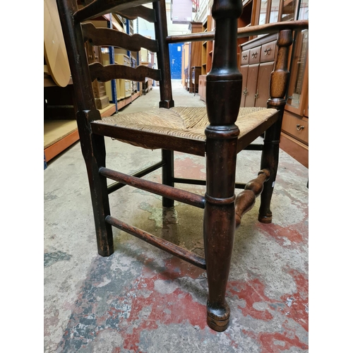 483 - A 19th century elm farmhouse ladder back armchair with rush seat and lower stretcher - measuring app... 