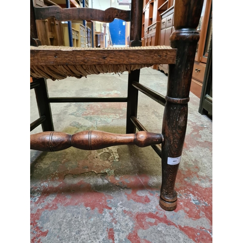 483 - A 19th century elm farmhouse ladder back armchair with rush seat and lower stretcher - measuring app... 