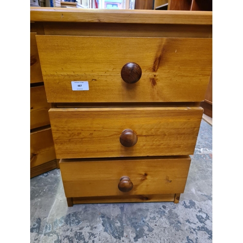 487 - A pair of modern pine three drawer bedside cabinets