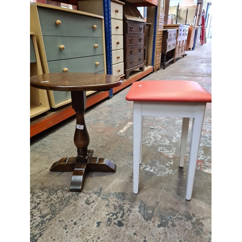 488 - An oak circular side table and a vintage white painted 'All British' stool with red leatherette upho... 