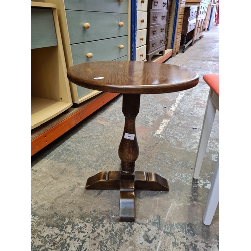 488 - An oak circular side table and a vintage white painted 'All British' stool with red leatherette upho... 