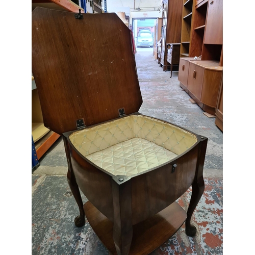 489 - Two items to include an oak circular side table on barley twist supports and a vintage walnut sewing... 