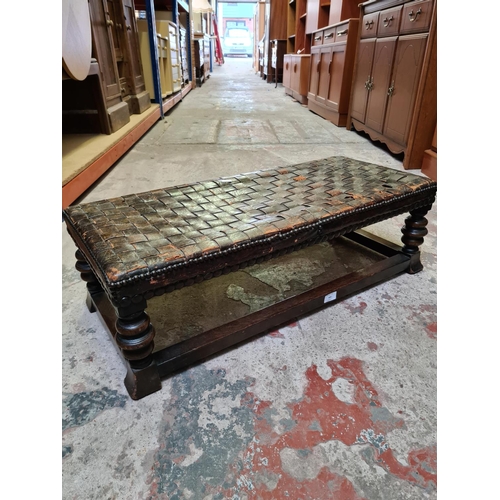 493 - A vintage oak and leather rectangular footstool