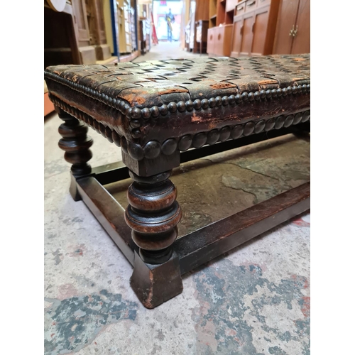 493 - A vintage oak and leather rectangular footstool