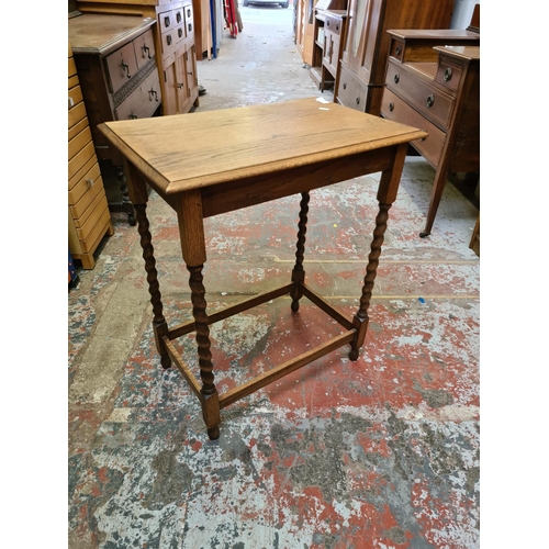 494 - An oak rectangular side table on barley twist supports